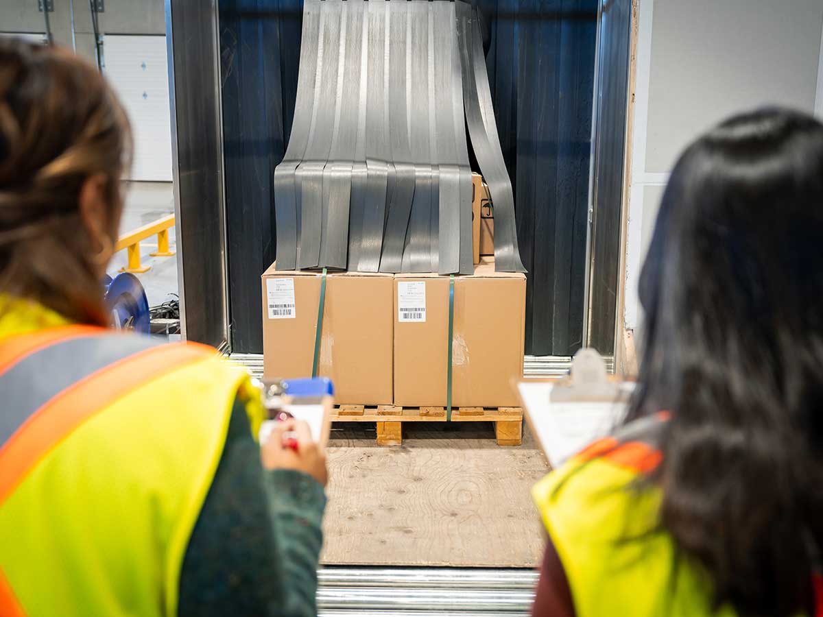 Two employees looking at a cargo shipment